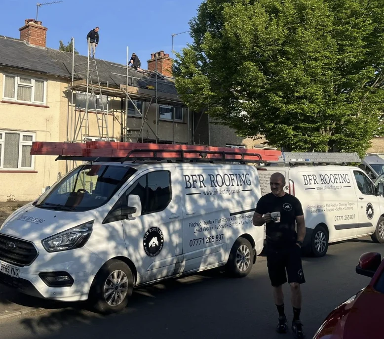 Ashley of BFR Roofing in front of their branded vans